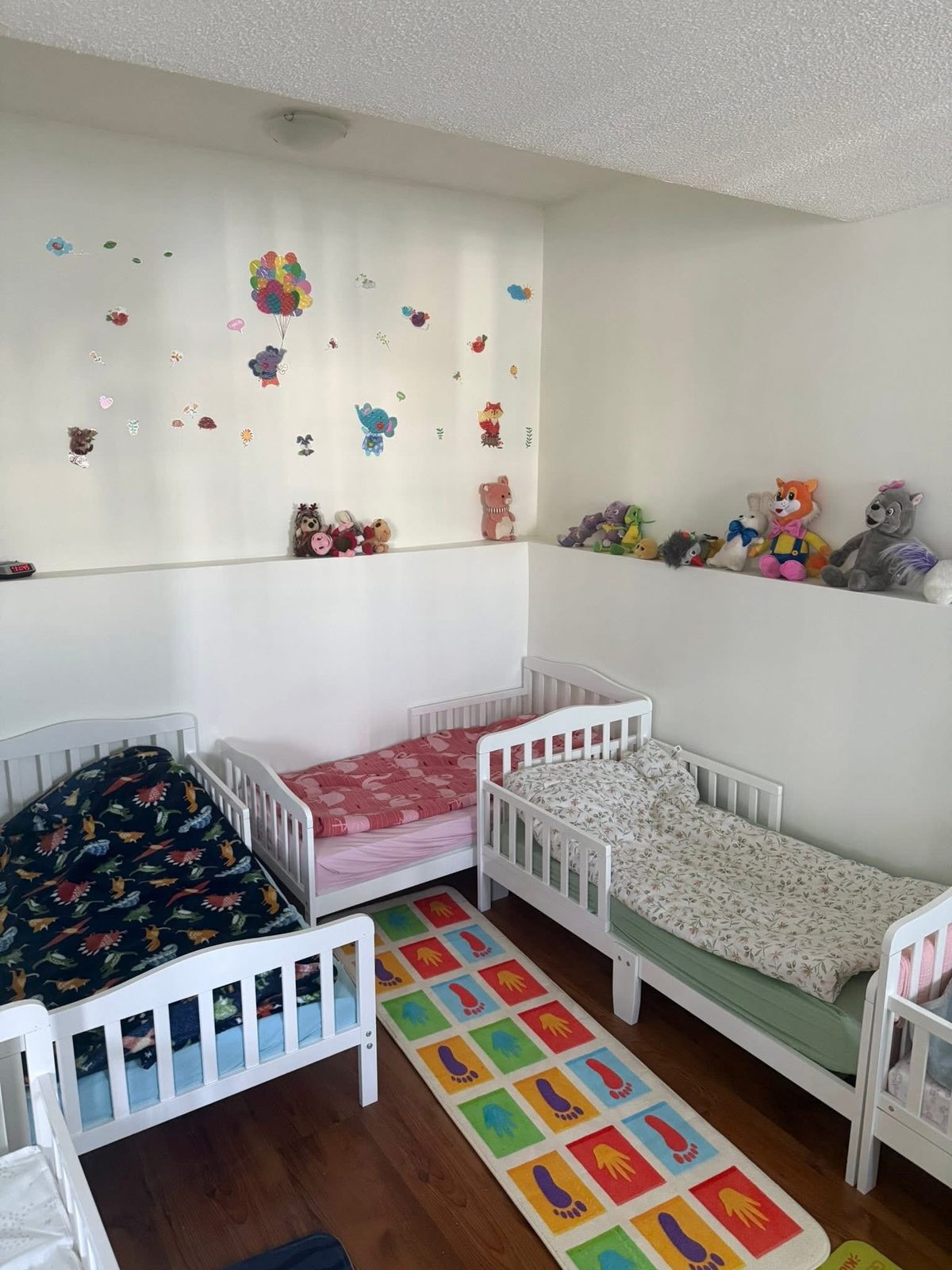 Cosy nap room with toddler beds and soft toys